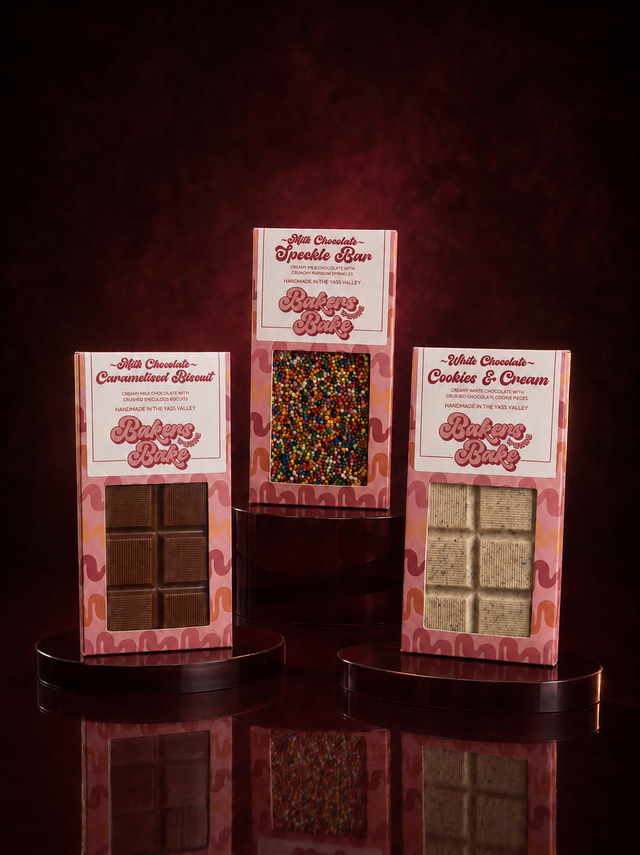 Three Bakers Wanna Bake chocolate bars in pink window boxes: milk chocolate Caramelised Biscuit, milk chocolate Speckle Bar and white chocolate Cookies and Cream